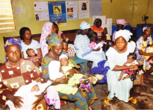 Young mothers being instructed how to care for their newborns