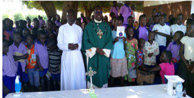 Father Gansonre with students